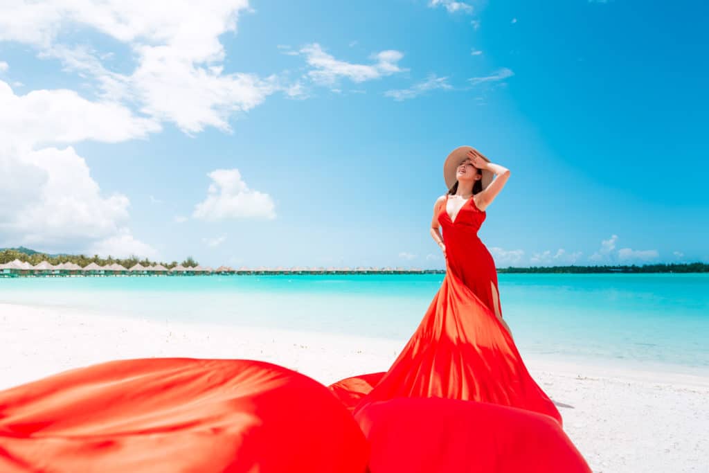 Red flying dress on a beach photoshoot