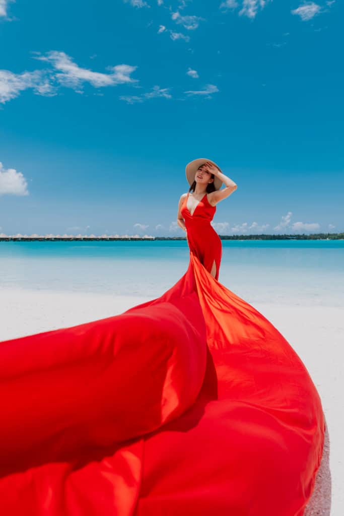 Red flying dress on a beach photoshoot